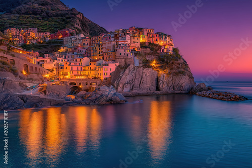 Dramatic sunset glow on Cinque Terre coastal village, Manarola