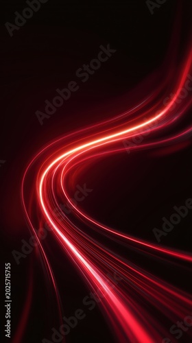 Abstract red light trails on a dark background creating a dynamic and flowing visual effect, suitable for backgrounds or digital designs
