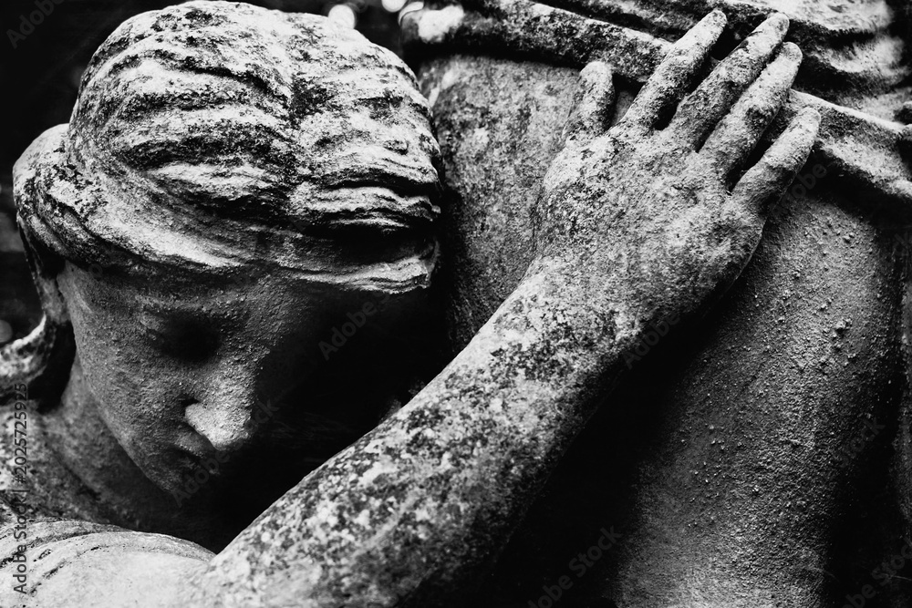 Obraz premium Weeping angel statue with tears in warm mystical light