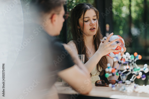 Εκτύπωση καμβά A teenage girl and classmate school friends examine a molecular model together