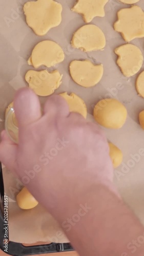 Womans puts gingerbread christmas cookies on a baking tray . High quality 4k footage