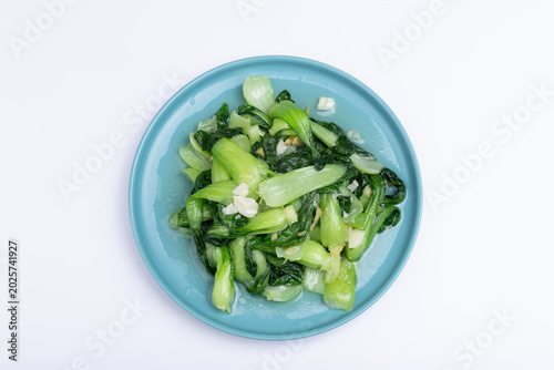 The stir-fried vegetables with green leaf lettuce on the plate