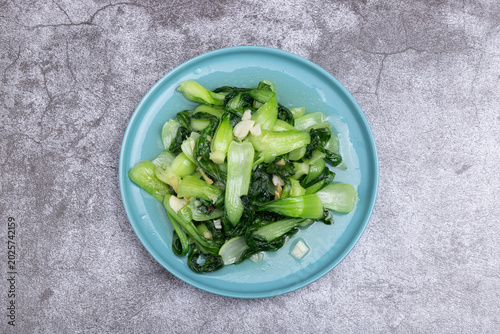 The stir-fried vegetables with green leaf lettuce on the plate