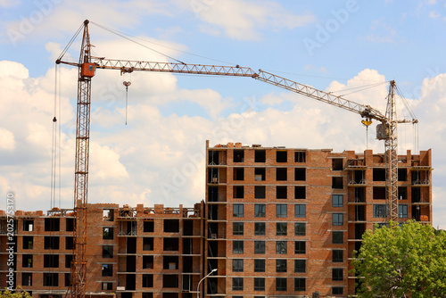 Foto Construction site with multi-story brick residential buildings and tower cranes