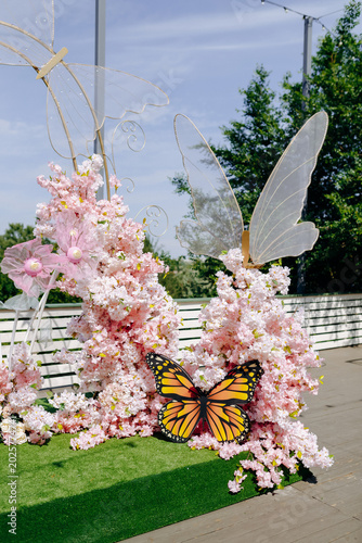 Bild auf Leinwand Vivid butterfly perched on vibrant blossom with detailed wings