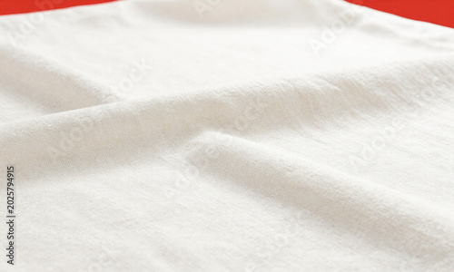 wide shot serene vintage white linen fabric stretching across frame subtly lit top emphasize gentle folds