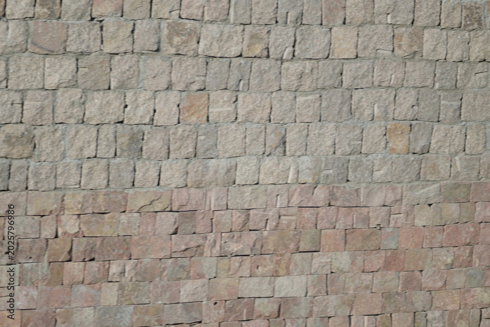 Naklejka premium Rough stacked stone wall background texture