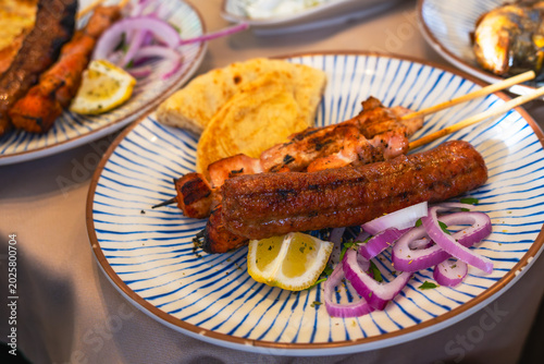 Grilled meat skewers with onion and lemon