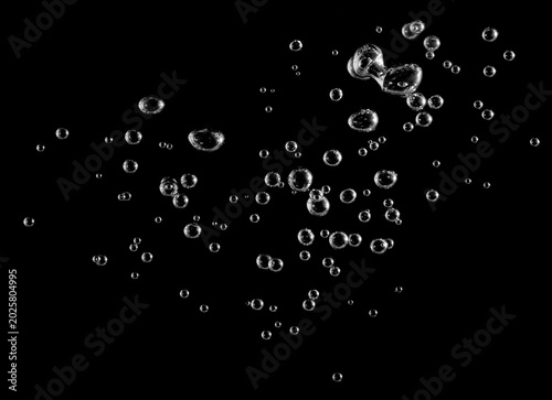 Schilderij op canvas Abstract underwater air bubbles isolated on black background, transparent oxygen spheres floating in liquid, macro splash texture for science, freshness, purity, beverage, and design concepts