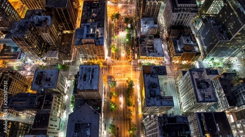 City skyline at night showing streets and buildings with lights in a large urban area during late hours