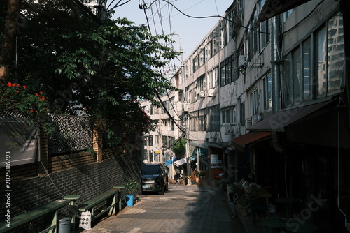 Narrow Sloping Alleyway Surrounded by Older Residential Buildings in Seoul