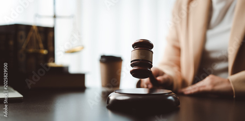 Fotografie Judge's gavel hitting block, symbolizing justice, law, auction, and important le