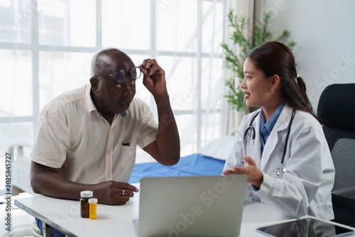 Bild auf Leinwand Female doctor providing medical care and offering professional advice to an elde