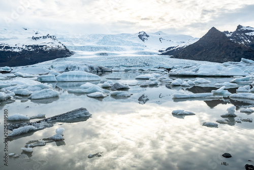 Glacier lagoon with icebergs floating at the foot of the Vatnajokull Glacier or Vatna Glacier, the largest and most voluminous ice cap in Iceland, and the second largest in area in Europe
