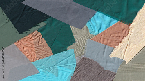 Fotografie Abstract Background of Colorful Fabric Scraps and Wrinkled Textile Remnants