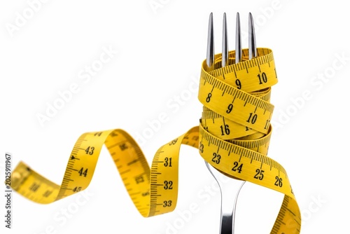 Fork Wrapped with Yellow Measuring Tape on White Background.
