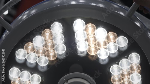 Close-up of advanced surgical operating lamp with bright LED lighting during medical equipment demonstration in clinical laboratory. Modern healthcare technology concept.