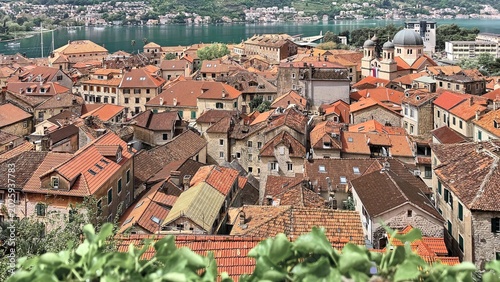 Kotor town rooftops and Bay of Kotor with mountain slopes in springtime