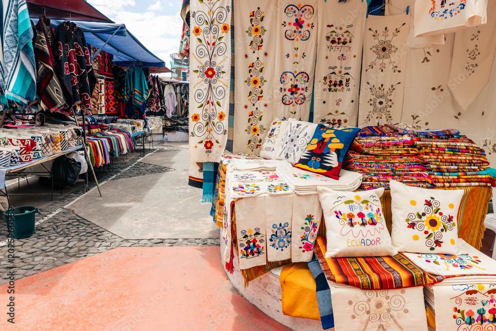 Fototapeta premium Otavalo Market Ponchos Plaza with Colorful Indigenous Textiles and Crafts, Ecuador