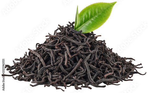 A substantial pile of dark, twisted black tea leaves, topped with a vibrant green isolated transparent background image
