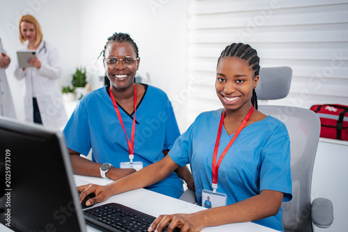 Medical staff collaborating at hospital office workstation