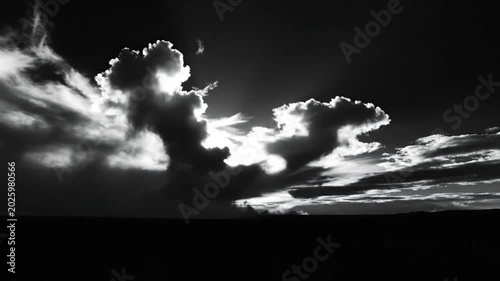 Dramatic black and white landscape of clouds illuminated by bright sunlight creating a tranquil and atmospheric scene