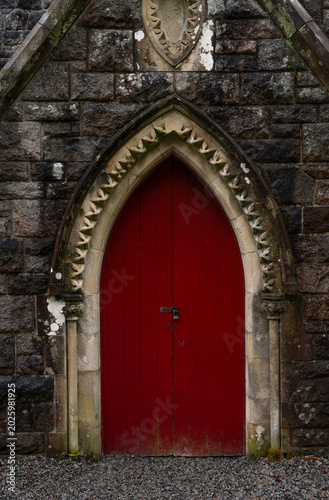 Old wooden red door in a church. St Conan's Kirk. Scotland