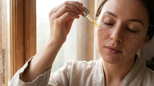 Woman applying facial serum for skincare routine