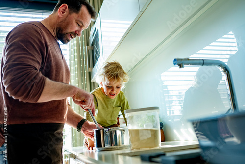 Canvastavla Dad and toddler preparing simple meal together in bright kitchen.
