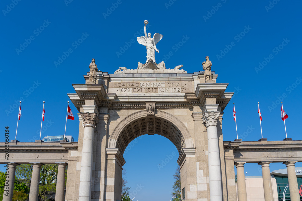 Fototapeta premium Princes Gates against blue sky at Exhibition Place in Toronto, Canada, in 2026. Princes Gates serves as a monumental gateway and the eastern entrance to the Canadian National Exhibition (CNE) grounds.