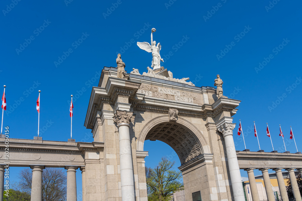 Fototapeta premium Princes Gates against blue sky at Exhibition Place in Toronto, Canada, in 2026. Princes Gates serves as a monumental gateway and the eastern entrance to the Canadian National Exhibition (CNE) grounds.