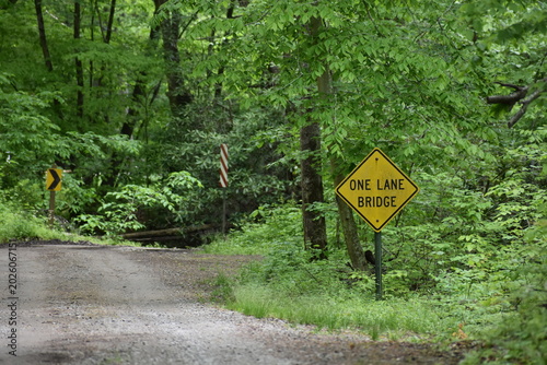 One lane bridge warning sign on a rural road