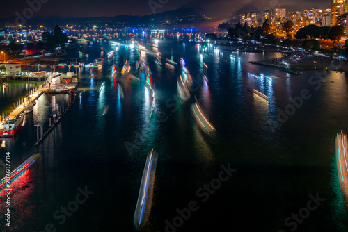 False Creek Boaters returning at Night. Long exposure of boaters returning to False Creek from English Bay at night after a firework show. Vancouver, British Columbia.
