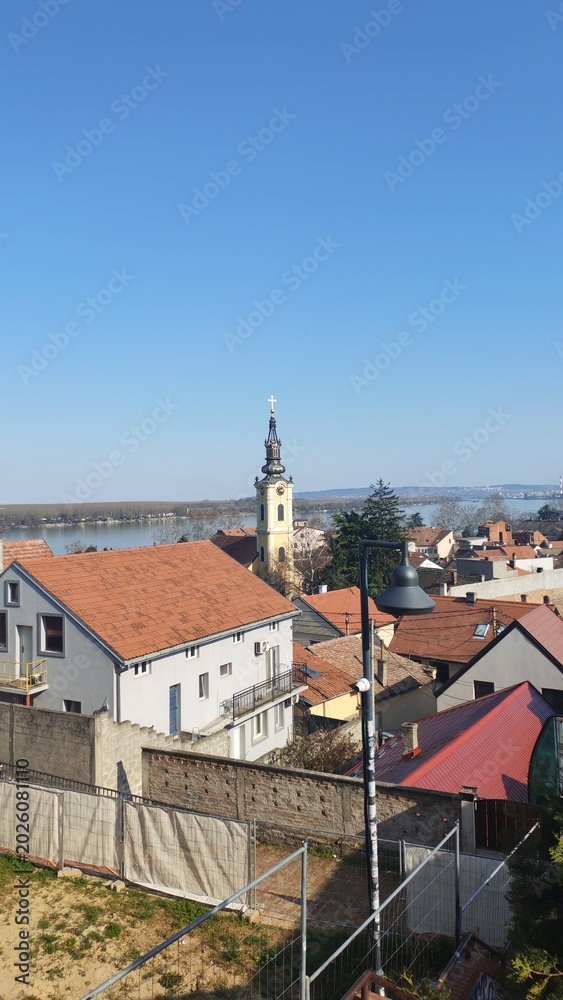 Fototapeta premium Elevated view of a city and river from a high vantage point. Urban landscape combining water, buildings, and surrounding environment in a wide panoramic scene.