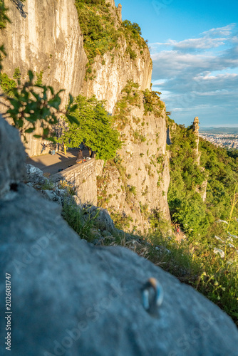 Limestone Cliff Face With Steel Abseil Bolt - Napoleonica Climbing Bouldering Area Trieste Karst, Adriatic Sea View Background, Italy Outdoor Sport Rock Climbing