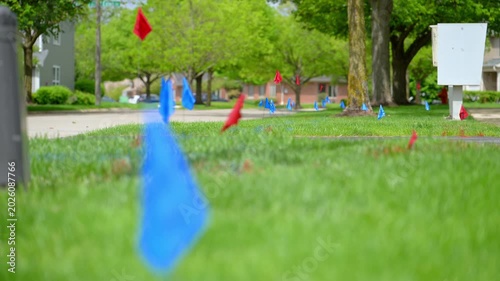 Colored utility marking flags placed in lawn for underground service and construction planning. 
