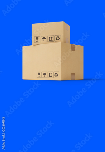 Two cardboard boxes of different sizes stacked on top of each other on a bright blue background. A minimalist 3D render with realistic corrugated texture and standard shipping icons