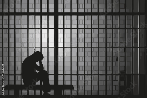 Konstfotografi prison cell silhouette with a seated despairing figure
