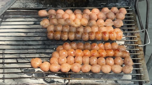 Thai Street Food Sausage Balls Cooking over Hot Coals