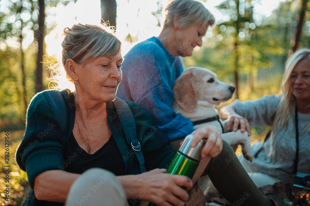Fototapeta premium Elderly female friendship drinking coffee in nature.