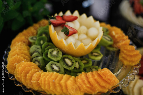 Luxury fruit platter served in an elegant restaurant setting. Fresh colorful fruits beautifully arranged on a decorative tray, perfect for themes related to fine dining, healthy food, catering, hospit