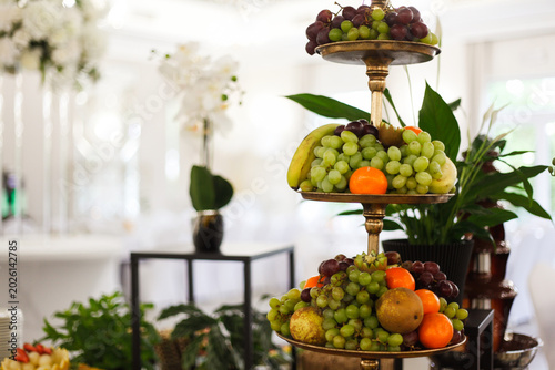 Luxury fruit platter served in an elegant restaurant setting. Fresh colorful fruits beautifully arranged on a decorative tray, perfect for themes related to fine dining, healthy food, catering, hospit