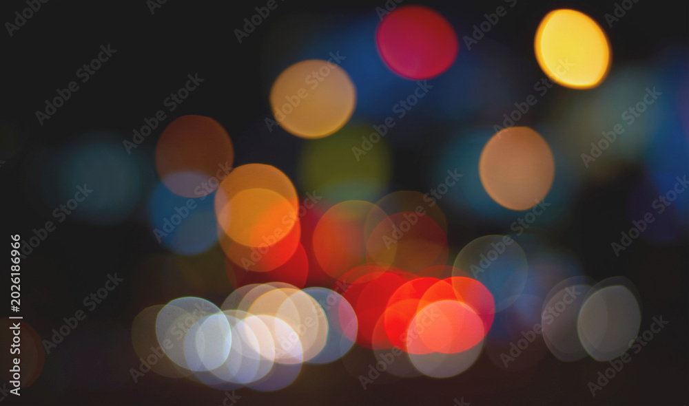Fototapeta premium Colorful bokeh orange red pink yellow circle overlay on dark background