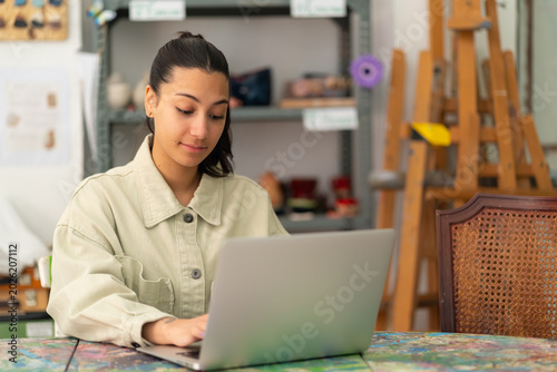Young woman creating digital content in art studio