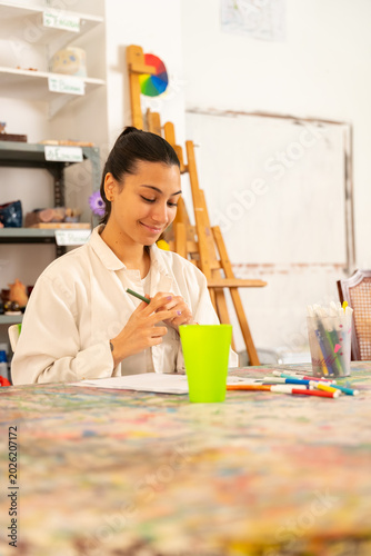 Young woman learning drawing in art studio