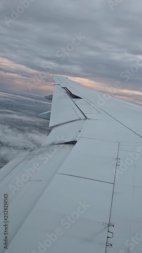 Vertical video of an airplane wing at dawn during a flight to Buenos Aires. Buenos Aires from above.

