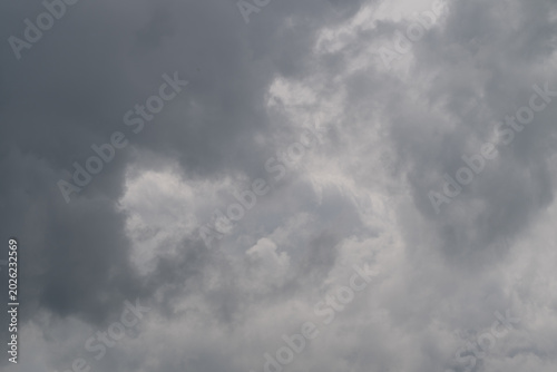 Fotografi Dark storm clouds gather overhead, heavy nimbus layers signaling incoming rain a
