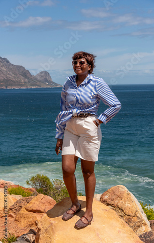 Koel Bay Western Cape South Africa. 14.02.2026.  Female holidaymaker standing  with a view of Kogel Bay a scenic coastal background in the Western Cape South Africa.