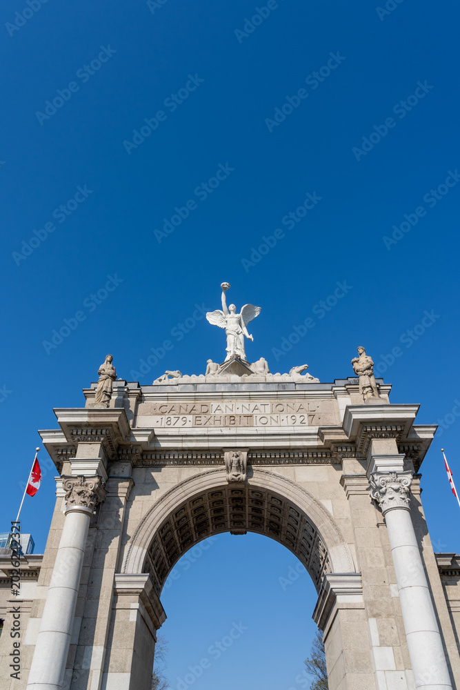 Fototapeta premium Princes Gates against blue sky at Exhibition Place in Toronto, Canada, in 2026. Princes Gates serves as a monumental gateway and the eastern entrance to the Canadian National Exhibition (CNE) grounds.