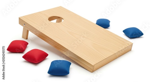 A slanted wooden cornhole board rests on a white background with red and blue bean bags scattered nearby for a classic outdoor game setup, target, outdoor, play